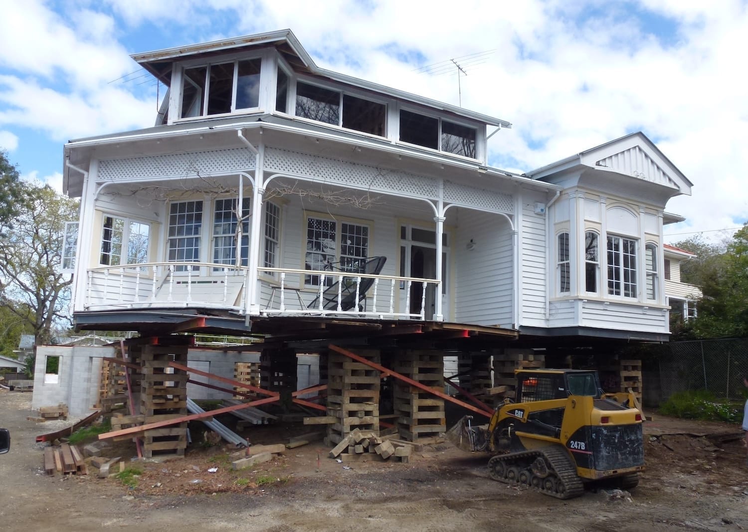 House fully elevated on timber cribbing during re-piling and foundation upgrade work